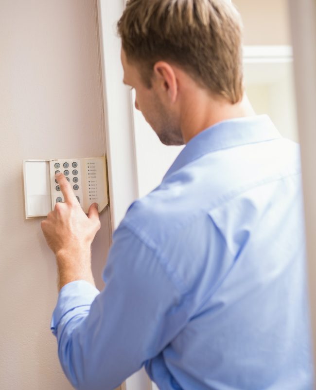 man-arming-a-home-alarm-on-the-wall.jpg man-arming-a-home-alarm-on-the-wall.jpg